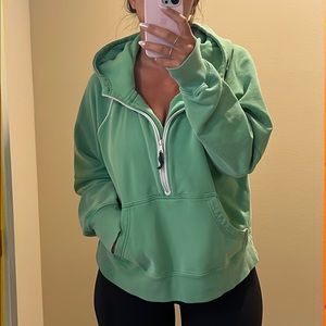 Green front zip pull over hoodie with white piping detail